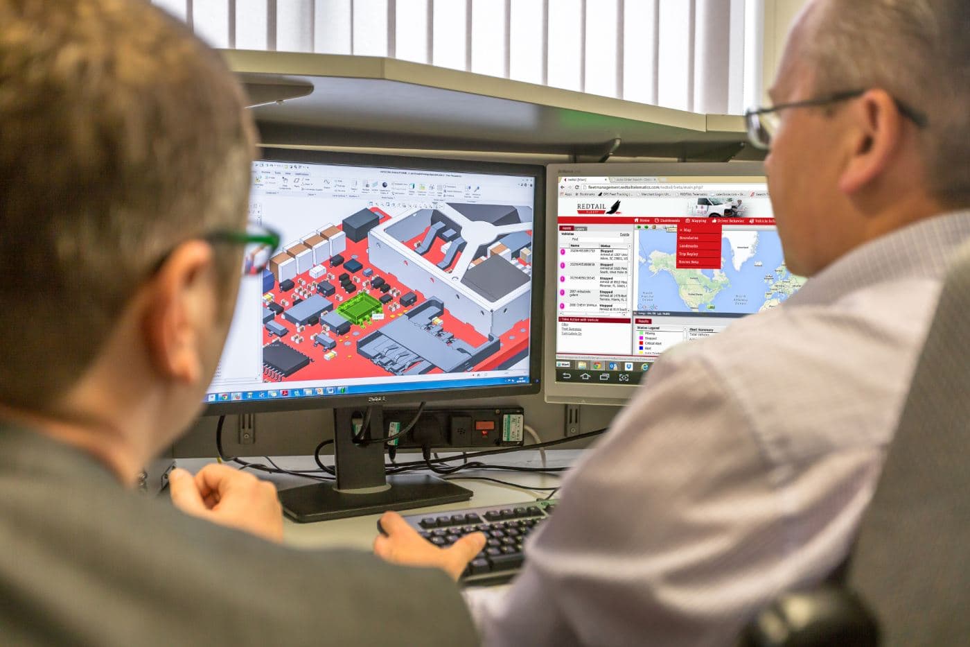 Redtail engineers reviewing a device design and the telematics portal
