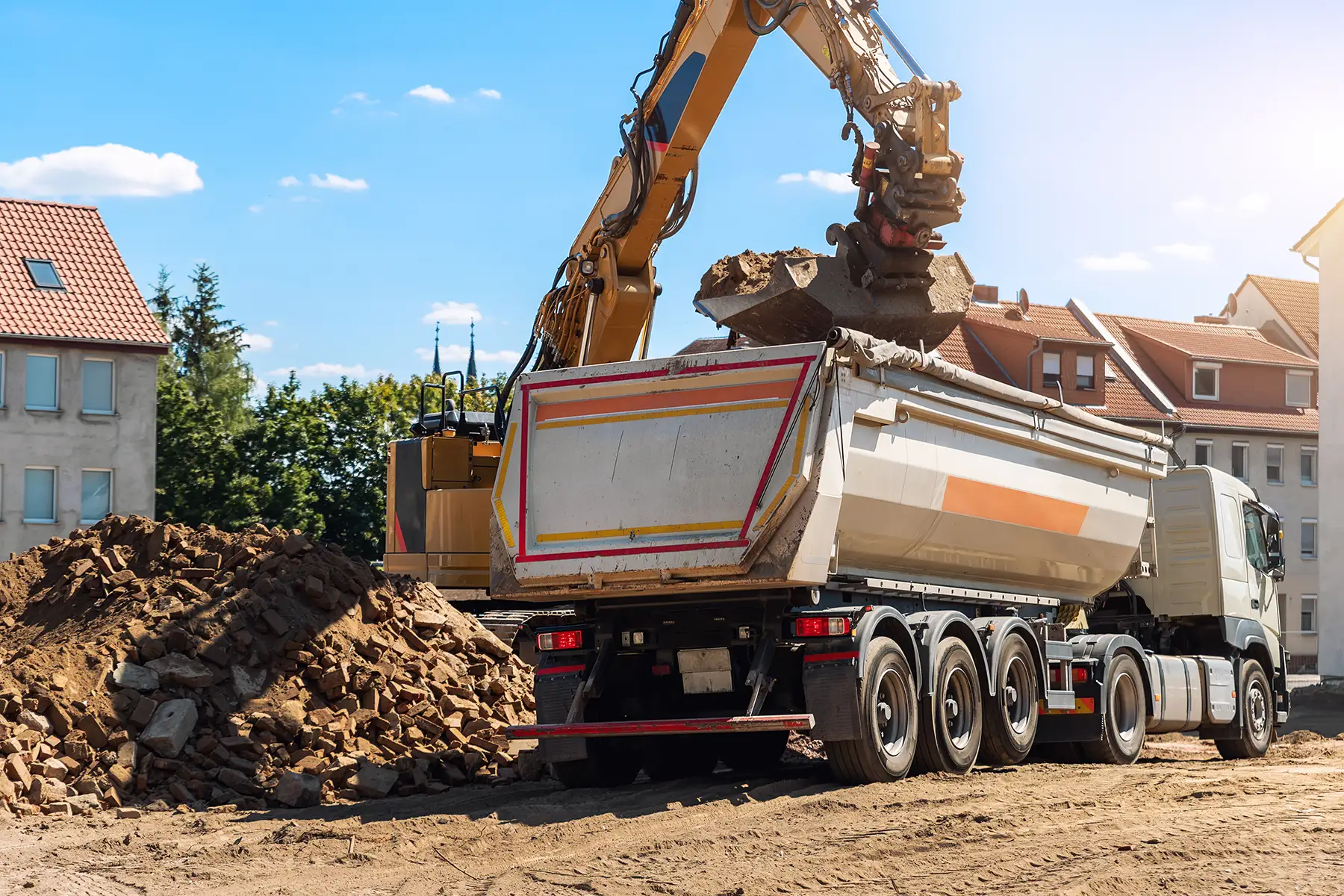 Construction truck being loaded by an excavator
