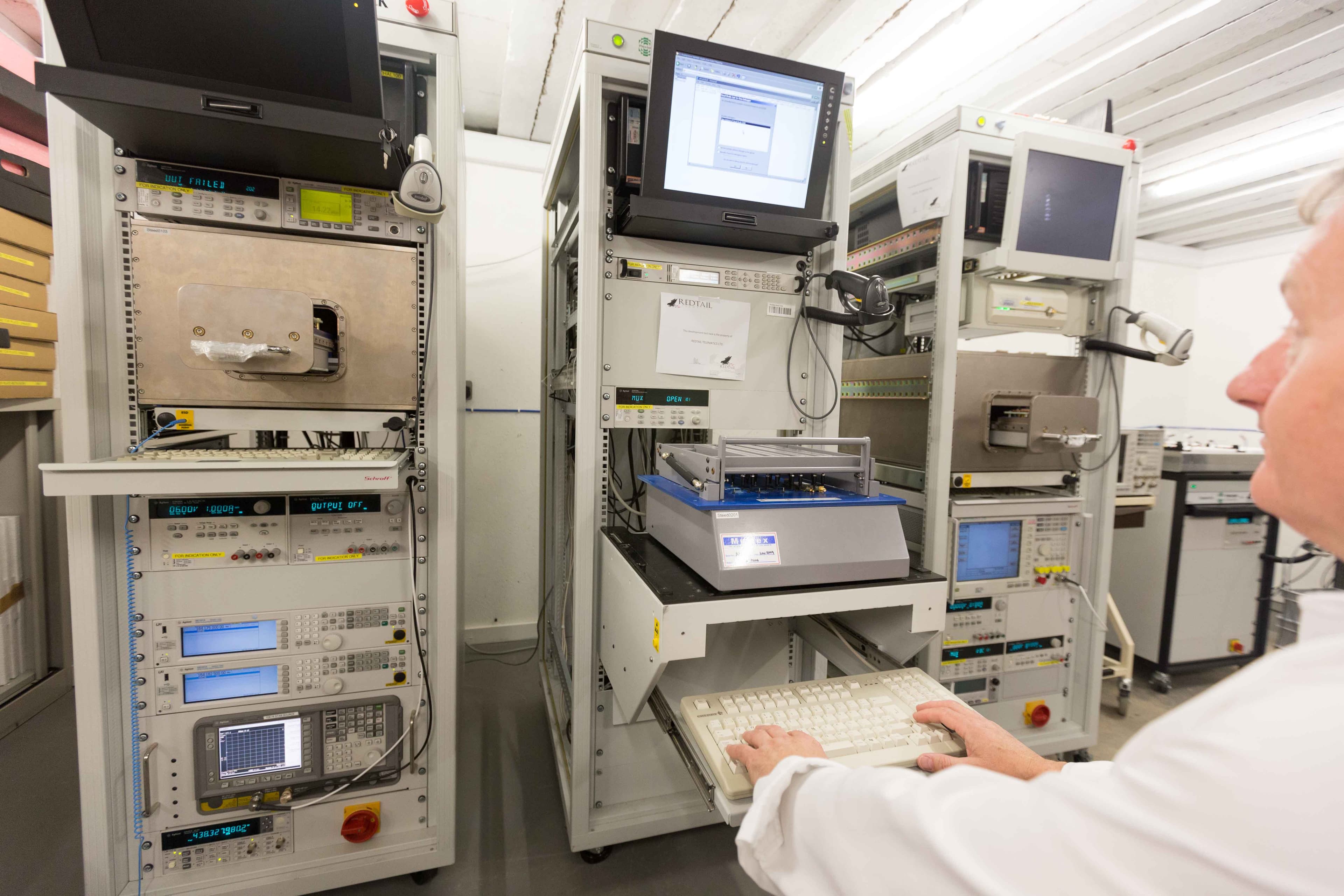 Redtail production line with engineers calibrating devices