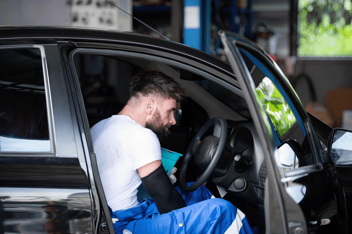 A vehicle installer working inside a car